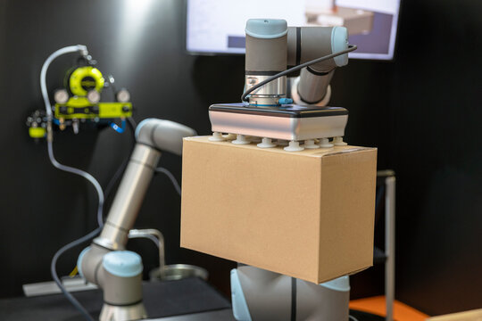 Robotic or robot arm for cardboard box packing
