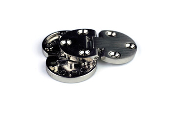 Chrome-plated metal hinges with screw holes, for doors and windows, insulated on a white background.