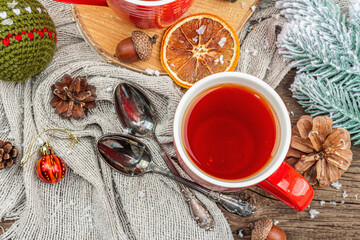 Winter cozy composition with hot tea and traditional Christmas decoration. New Year balls