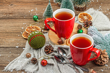 Winter cozy composition with hot tea and traditional Christmas decoration. New Year balls