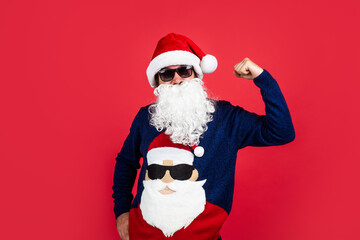 brutal bearded guy in santa claus hat and sweater on christmas eve, new year party