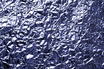 Abstract crumpled foil background, metallic foil texture, metallic foil texture tinted trend color Very Peri