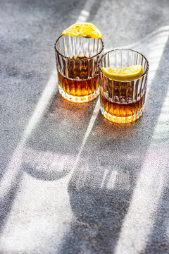 Close-up of two glasses of cognac with lemon slices