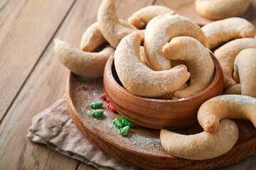 Christmas cookies crescents. Homemade traditional Christmas cookies Vanilla crescents in rustic plate with christmas decorations on old wooden rustic background. Food pattern. Holiday baking concept.