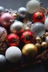 Various colorful Christmas ornaments on dark background, selective focus.
