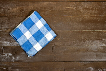 top view of Empty wooden table with plaid tablecloth 