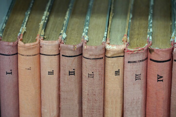 Covers of old books bound in cloth and volume numbers on the spine