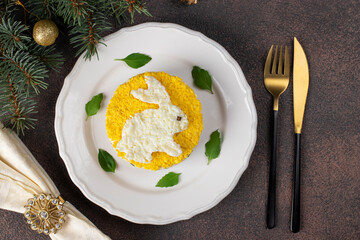 Puff salad Mimosa for the New Year 2023 with canned tuna, potatoes and carrots, decorated bunny...
