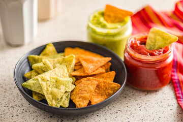 Tortilla chips with the flavor of chili and jalapeno peppers on plate.