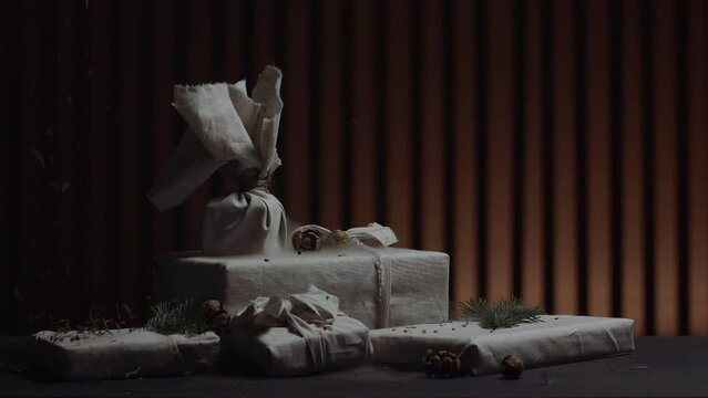 Eco-friendly gifts, decoration with twigs. Sustainable gift packaging. Plastic-free packaging, recycled paper and twine. interesting light