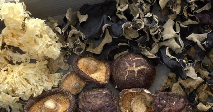 Assortment of dried mushrooms. Different species of Asian dry fungi. Table spin.