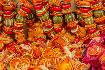 Christmas and New Year wreath with dried oranges, lime and spices. Holiday winter background. Citrus aroma and flavoring.