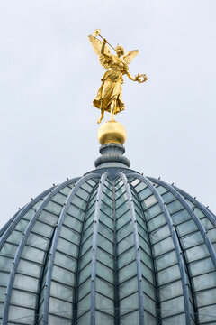 The glass dome with golden statue of Pheme of Dresden Academy of Fine Arts, Dresden, Germany