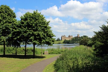 Fototapeta na wymiar Linlithgow Palace and St Michael's Church, with Linlithgow Loch in the foreground.