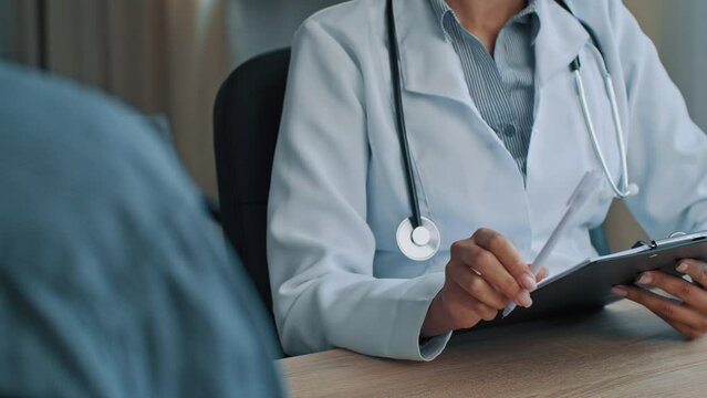 Young professional female general practitioner african woman doctor therapist listen patient complaints give medical advice to sick client write prescription med insurance checkup visit at hospital