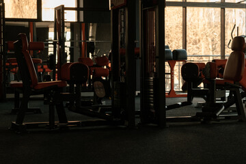 Naklejka na ściany i meble Sports equipment in the gym. Stylish sports space. Expanders and trainers with block weights