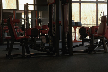 Naklejka na ściany i meble Sports equipment in the gym. Stylish sports space. Expanders and trainers with block weights