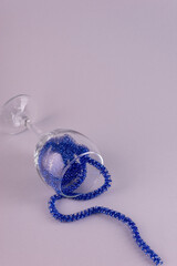 christmas in a wine glass. New Year's rain in a glass on a plain background