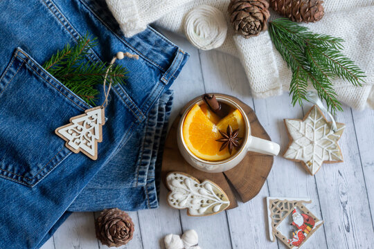 Hot tea with orange, sweets and decorations for the new year. © ostapenkonat