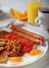 Fototapeta na wymiar Traditional British breakfast with sausages and beans