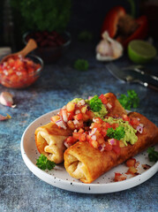 A typical dish of Mexican cuisine - Chimichanga, made of tortilla with different ingredients