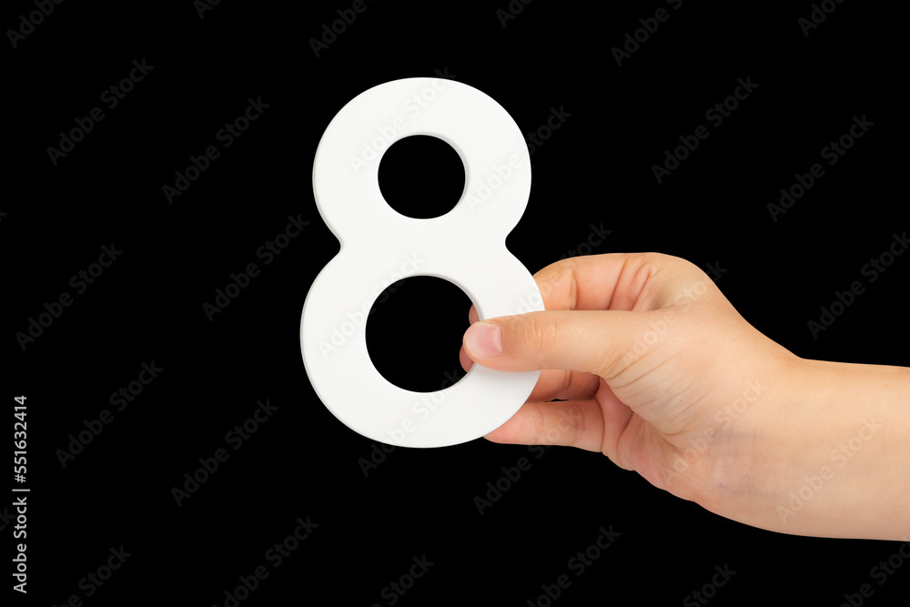 Aufkleber Number eight in hand isolated on black background. Number 8 in a child's hand on a black background. To be inserted into a project or design.