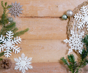 fir branches, snowflake ornaments and christmas balls on wooden ground with space for text