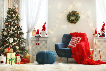Cute Christmas gnomes in room with other festive decorations