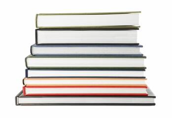 Many different books stacked on white background