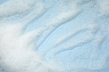 White washing foam on color background, top view