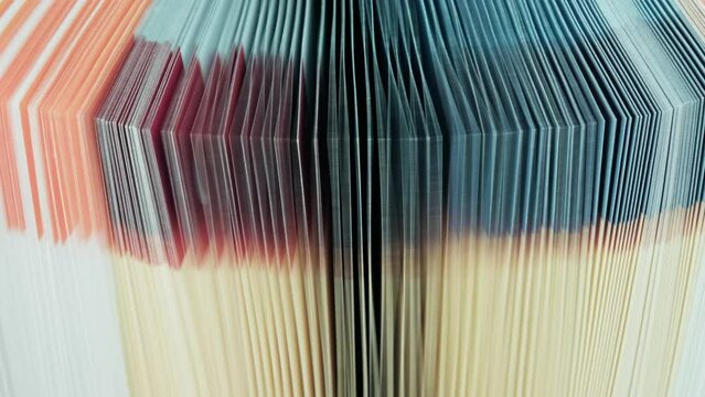 Edge of colorful opened book pages, close-up