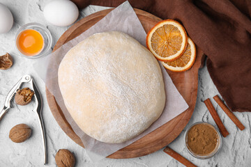 Fresh dough and ingredients on white table, flat lay