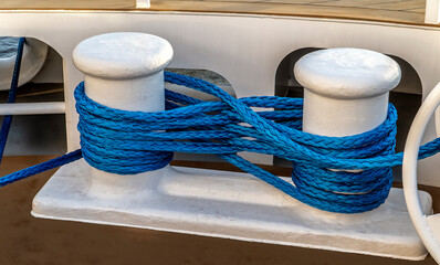 Nautical moorning lines used for mooring a ship. Photo of a double bitt bollard. It allows acceptance of multiple mooring lines in a confined space.