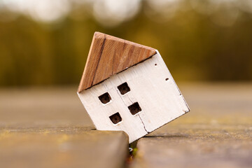 Wooden house miniature with cracks in the plank break outdoor