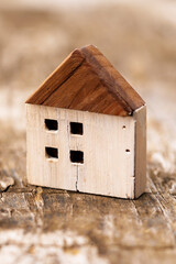 Cracked wooden house model on a grunge board