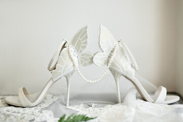 Elegant bride`s heels in form of butterfly, prepared for wedding ceremony