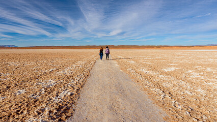 Two girls walking in a salt lake