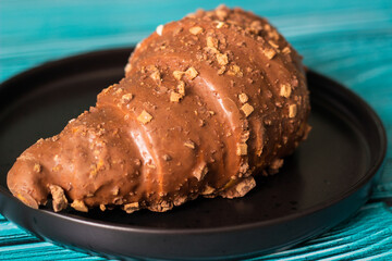 Freshly chocolate croissant on plate