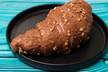 Freshly chocolate croissant on plate