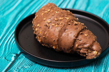 Freshly chocolate croissant on plate