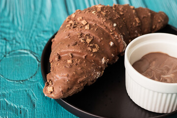 Sweet chocolate croissant and chocolate sauce