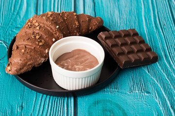 Croissant with chocolate bar and chocolate spread