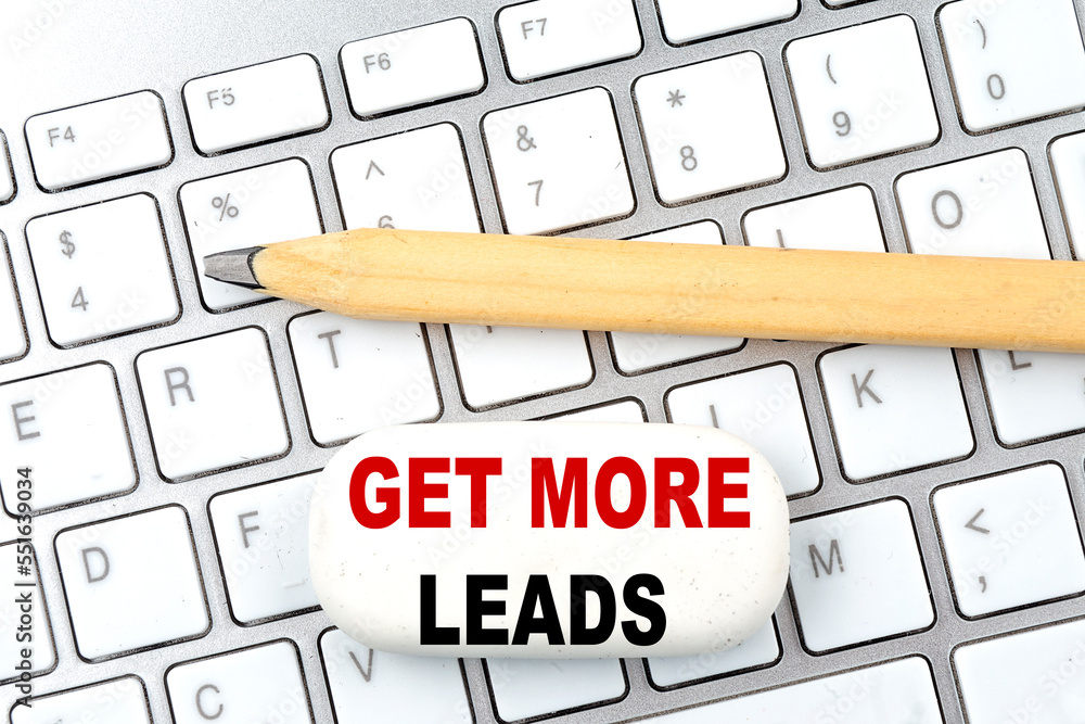 Poster get more leads text on eraser with pencil on keyboard