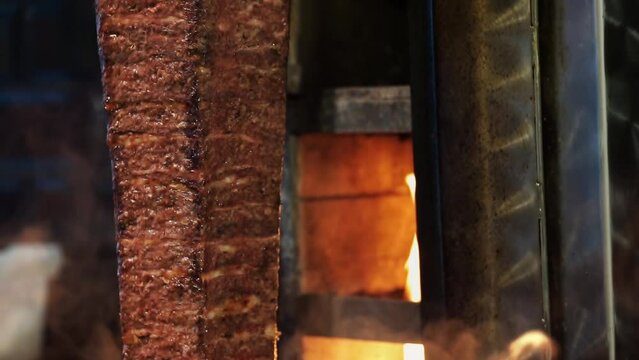 Meat doner cut close-up videos, cutting hanging doner. Turkish kebab iskender. Shawarma meat being cut before making