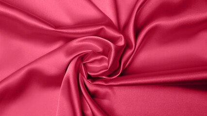 Viva Meganta toned red magenta fabric atlas. Close up pink silk satin texture for sewing. Abstract...