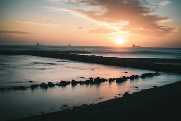 Beautiful sunset long exposure with rocks, Civitavecchia (Rome) Italy	