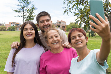 group of friends taking a selfie exercising in the park