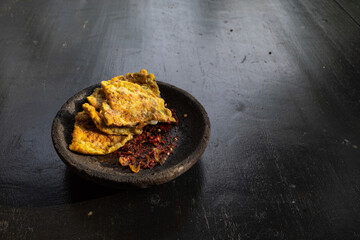 Omelet served with red chili sauce