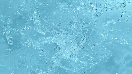 Water splash isolated on soft blue background.