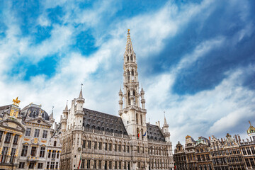 Fototapeta na wymiar Brussels Town Hall building with tall spire and other guild houses in the Grand Place in Brussels, Belgium